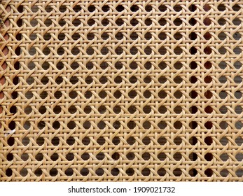 Close Up Of The Pattern Formed By Open Weave Rattan Cane On A Chair Seat