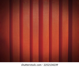 Close up pattern line of orange or red plastic curtain with vignette tone for background. Abstract, wall or wallpaper concept 