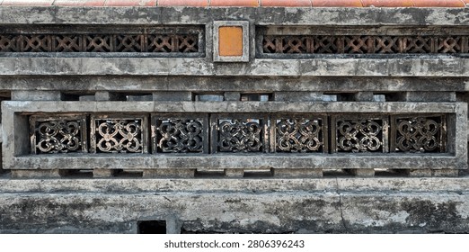 Close up pattern of molded clay blocks or ceramic Roster, in flower pattern, installed on a weathered aged wall. Found in old ruins or ancient palace or building. Heritage concept. Seamless texture