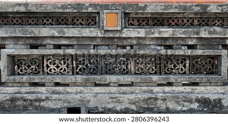 Close up pattern of molded clay blocks or ceramic Roster, in flower pattern, installed on a weathered aged wall. Found in old ruins or ancient palace or building. Heritage concept. Seamless texture