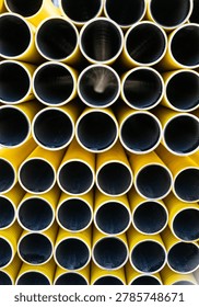 Close up pattern of yellow plastic pipes forming geometric industrial texture background