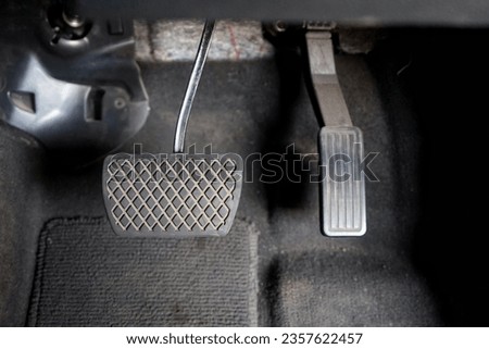 close up of the pedals and brakes of an automatic car