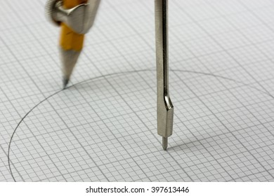 Close Up Of Pencil Drawing A Circle On Graph Paper