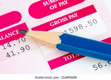 Close Up Of Pencil And Wage Slip