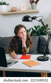 Close Up Of Pensive Little Girl Child Writing Notes Study With Laptop And Books, Serious Small Kid Doing School Tasks At Home, Writing Notes, Getting Bored During Remote Class, Looking At Window