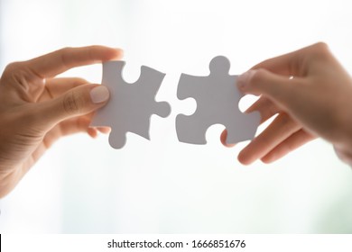 Close Up Of People Assemble Jigsaw Puzzle Find Perfect Match, Business Solution, Diverse Employees Put Pieces Together Engaged In Teambuilding Activity At Work, Teamwork, Creative Thinking Concept