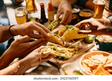 Close up of people eating Mexican food in a restaurant.  - Powered by Shutterstock