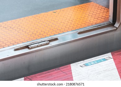 Close Up People Feet Walking Over The Gap Between A Metro Train And Platform. People Can Fall Into This Gap And Get Injured