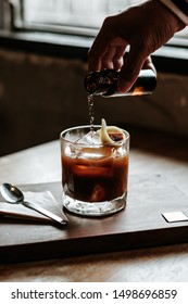 Close Up People Hand Pouring Soda Water Into A Glass Of Iced Espresso Coffee