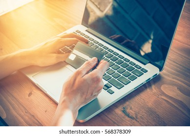 Close Up People Hands Holding Credit Card And Typing Laptop Keyboard In Online Shopping,payment And Finance Concept