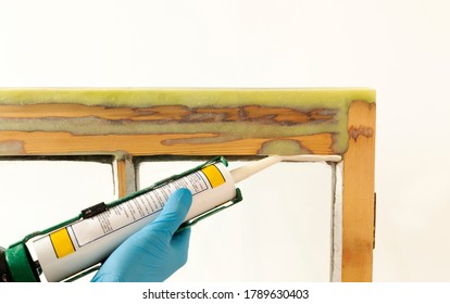 Close Up Of A Person Applying Dry Seal To Restored Sash Windows.