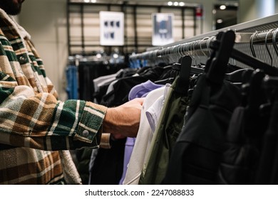 Close up of person chooses clothes in store - Powered by Shutterstock