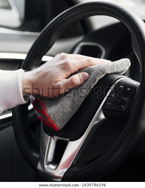Close up of person\
cleaning car interior