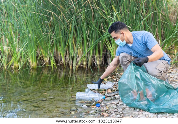 Close Up of Person\
Collecting Plastic From the River. Man Cleaning River of Plastics.\
Environment Concept.