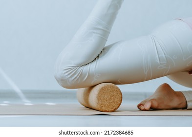 Close Up Of Person Doing Quadriceps Muscle Fascia Release With A Cork Roller. Concept: Pre-sport Tissue Hydration, Pre-sport Warm Up, Quad Tension Release