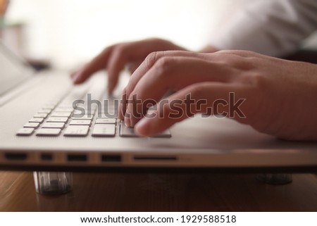 Close up of person hand typing on laptop keyboard, author writing on pc computer, businessman programmer working concept