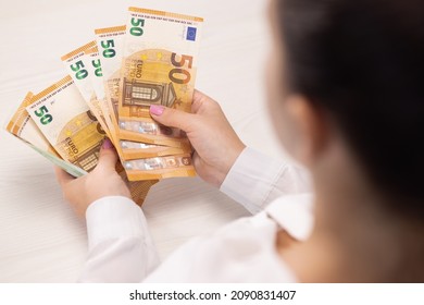 Close up of Person Hands Counting Money, Salary, Income, Savings, Money, Euros. Woman count euro 50 banknotes. Family budget. Count euros, Money counting