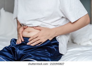 close up of a person holding his fat belly