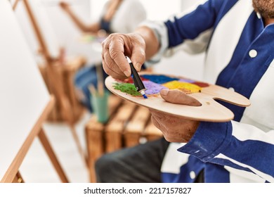 Close Up Of Person Pouring Oil Paint On Colorful Palette At Art Studio