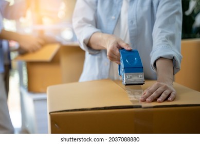 close up person sealing tape on parcel box prepare for delivery service to pick up.