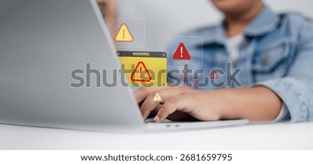 Close up of person using laptop with multiple warning alert icons on screen, concept of cybersecurity, malware, system error, online threat, data protection and internet safety.