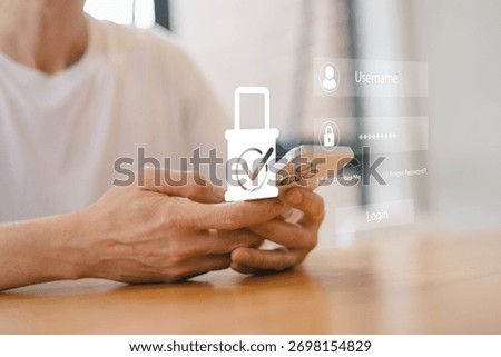 Close up of person using smartphone with digital login interface and security icon overlay, illustrating mobile cybersecurity, user authentication, data privacy, and secure access technology.
