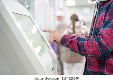 close up person using touch screen panel in post office to recieve a package