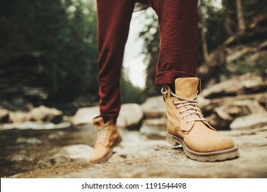 Close up of persons comfortable boots for activities in the forest - Shutterstock ID 1191544498