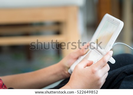 Close up of persons hands playing a game.