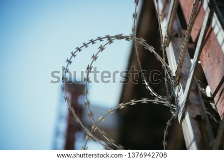 Close up perspective of barbered wire in the prison or on a military base
