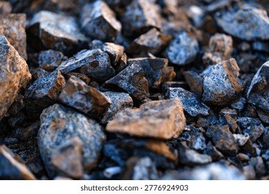 Close perspective capturing the harsh purity and unblemished angular surfaces of countless dry crushed stones resting on the ground.