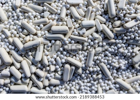 A close up perspective of ceramic media used in rock tumbling for polishing rocks and stones. Great for backgrounds used with marketing for hobby rock tumbling ads or websites!