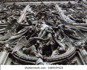 Close Up Perspective Of Descent Of Jesus From The Cross In Duomo Di Milano Principal Door 