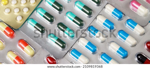 close up pharmaceuticals antibiotics pills\
medicine in blister packs. colorful antibacterials pills Pharmacy\
background. capsule pill medicine Antimicrobial drug resistance.\
Pharmaceutical industry