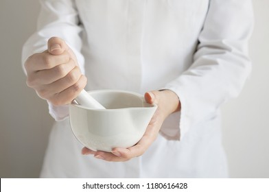 Close Up Of A Pharmacist Using Mortar And Pestle In The Pharmacy