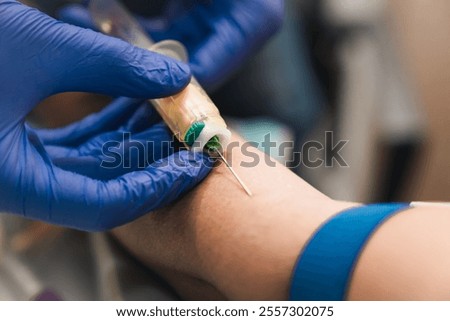 close up of phlebotomy process for blood testing