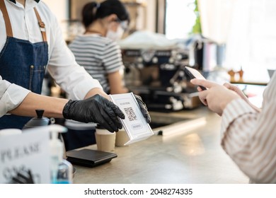 Close Up Of Phone Scan QR Code To Pay For Service And Drink In Cafe. Woman Customer Handing Smartphone Make A Quick And Easy Contactless Payment To Barista Waiter In Restaurant During Covid 19 Pandemi