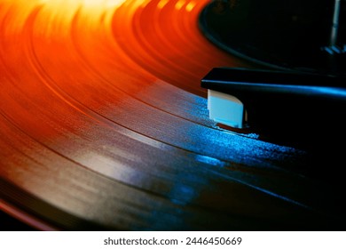 Close up photo of analog music player playing on turntable with needle illuminated in warm, cozy sunset light. Concept of art, retro music, vintage, disco, nostalgy, old-fashion. Ad - Powered by Shutterstock