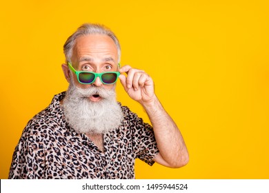 Close up photo of astonished man seeing something strange in front of him while isolated with yellow background