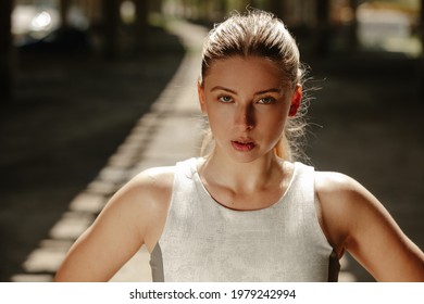 Close Up Photo Of Athletic Blonde Woman Sweating Taking A Break From Workout And Looking At The Camera.