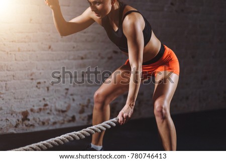 Similar – young adult trained woman concentrate at her excercise in gym