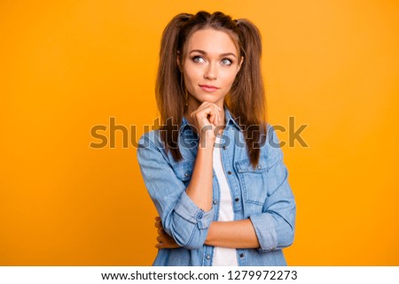Close up photo of attractive wondered brunette she her lady with ponytails arm on chin looking to empty space wearing casual denim jeans shirt clothes isolated on yellow vivid bright background