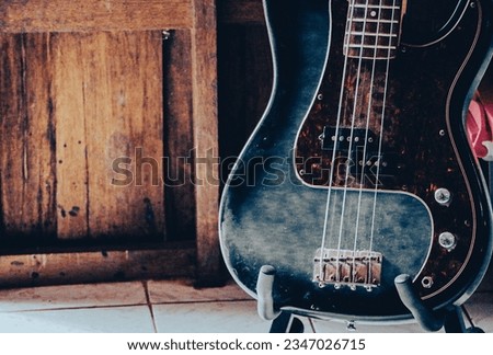 Close up photo of bass guitar or electric bass is the string instrument. This guitar type has four string in lower pitch sound same as the double bass