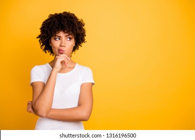 Close up photo beautiful amazed she her dark skin lady arms hands chin think over not sure homework diligent student look empty space wearing casual white t-shirt isolated yellow bright background - Shutterstock ID 1316196500