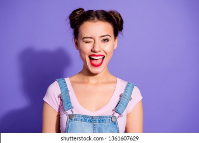 Close up photo beautiful amazing she her lady two buns open mouth wink boys guys cheerful pretty red lips pomade wear casual t-shirt jeans denim overalls clothes isolated purple violet background