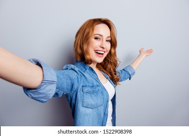Close up photo beautiful amazing she her lady hold arm hand air make take selfies modern technology direct way foreigners travelers wear casual blue jeans denim shirt isolated grey background
