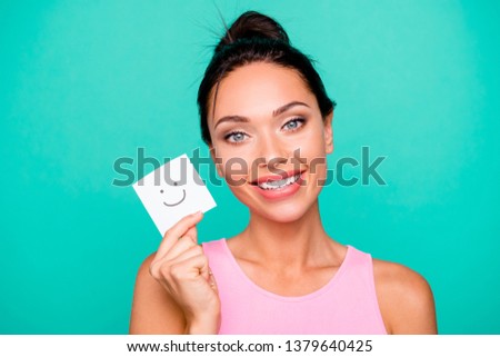 Close up photo beautiful amazing she her lady funny hairstyle hold hands arms paper mood drawing overjoyed pick select nice mask wear casual pink tank-top isolated teal turquoise background