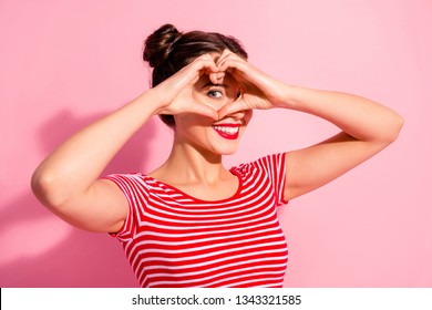 Close Up Photo Beautiful She Her Lady Pretty Two Buns Pomade Lips Hold Hands Arms Heart Shape Figure Near Eye Hide Face Cardiac Health Wear Casual Striped Red White T-shirt Isolated Pink Background