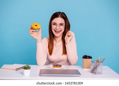 Close up photo beautiful she her foxy lady hand arm sweet bakery yummy sugary donut sprinkles plate diary flowerpot pencil case table desk wear specs pastel pullover isolated bright blue background - Powered by Shutterstock