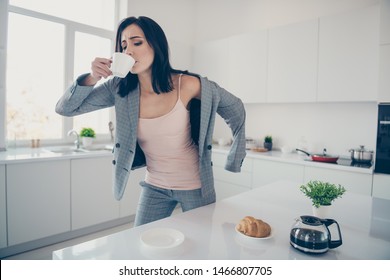 Close up photo beautiful she her lady hot beverage swallow sip croissant table late job quickly dressing jacket blazer exhausted formal-wear checkered plaid costume bright white kitchen indoors - Powered by Shutterstock